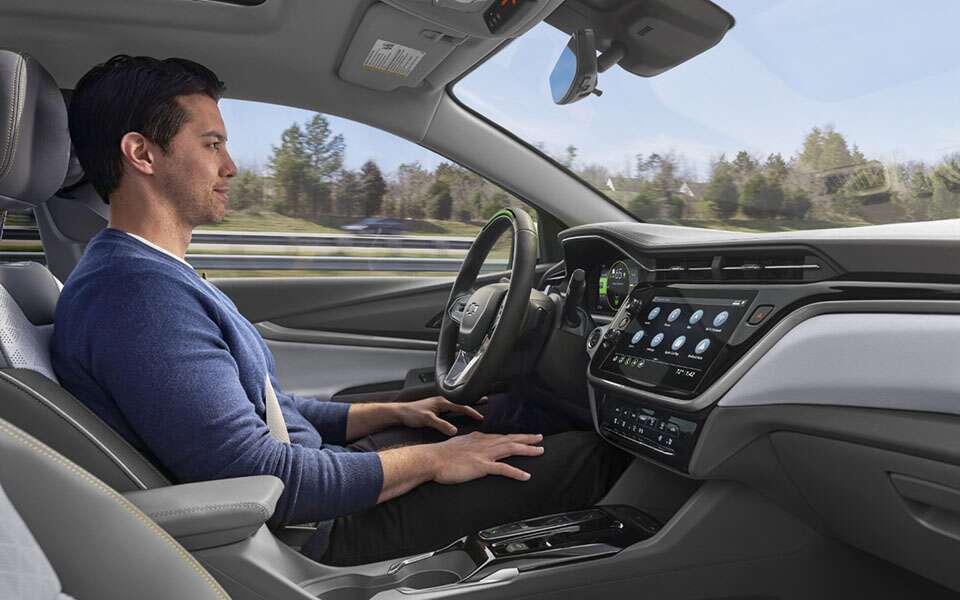 Man Utilizing the Super Cruise Hands-Free Driving Component in His GM Vehicle  
